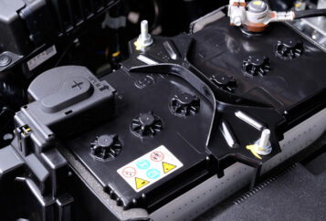 A auto battery inside of a car.