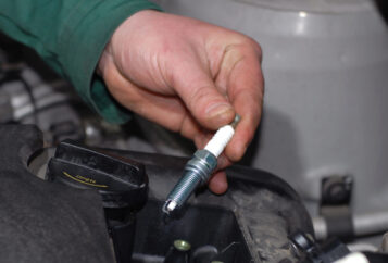 Automotive Tune-Up: Hand Holding Spark-Plug.